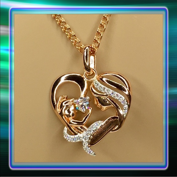 mother holding baby necklace